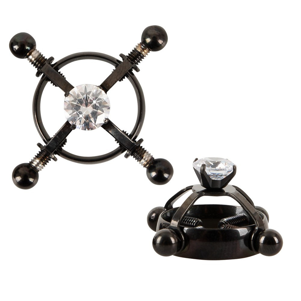 Black metal device with diamond-like crystals on a white background
