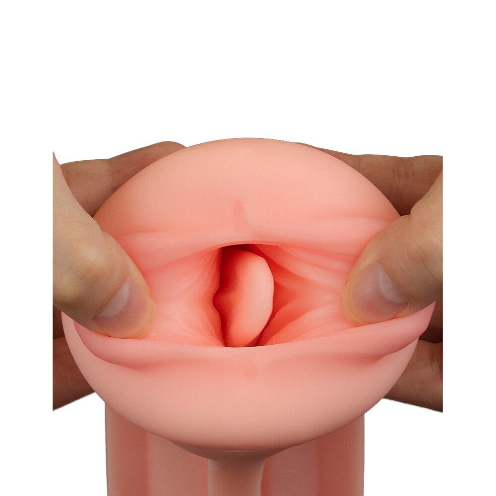 Pink silicone mouth held between fingers on a white background