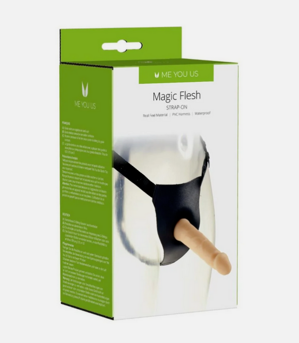 Product packaging for 'Magic Flesh' strap-on with green and white design.