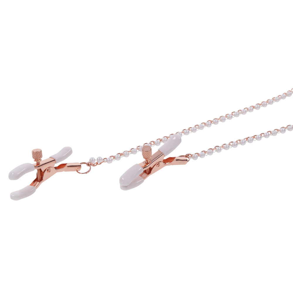 Necklace with rose gold nipple clamp and white beads on a white background