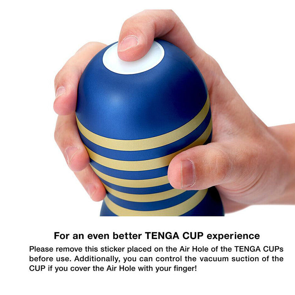 Blue and gold striped Tenga cup held in a hand with text instructions.