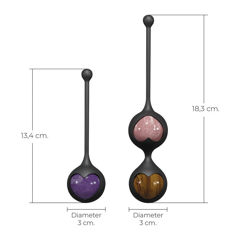 Two black spherical sex toys with heart-shaped compartments, one purple and one brown, on a white background with measurements.