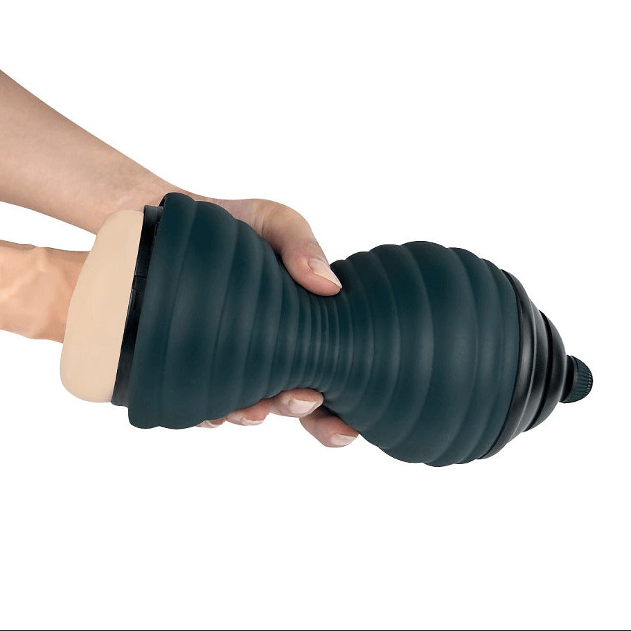 Person holding a dark green silicone masturbator against a white background