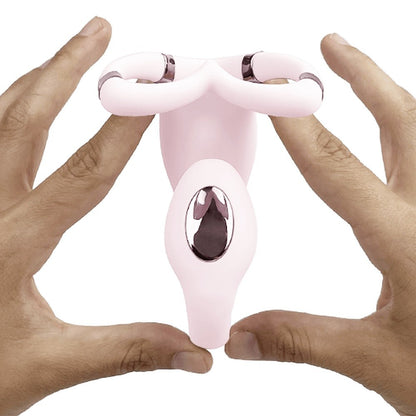Pink and silver device held between two hands on a white background