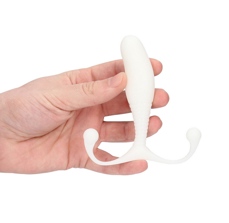 White plastic anal toy held in a hand against a white background