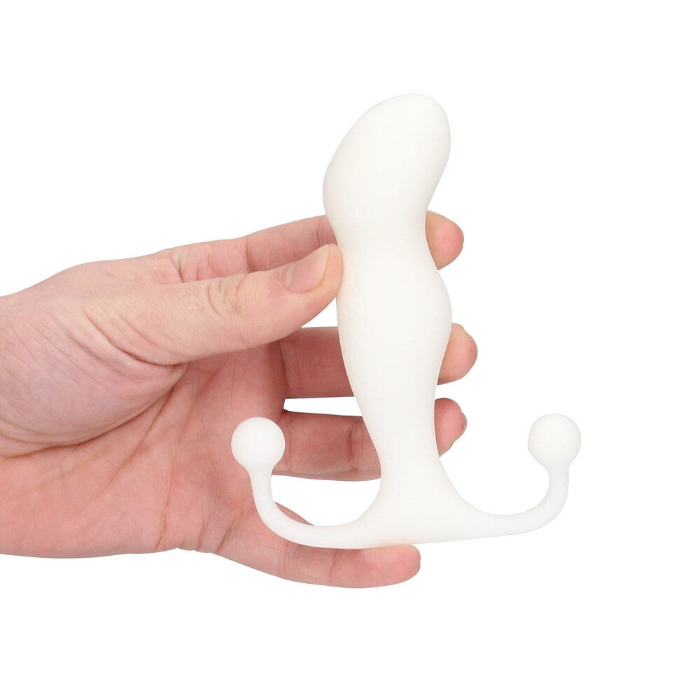 White prostate massager held in a hand against a white background