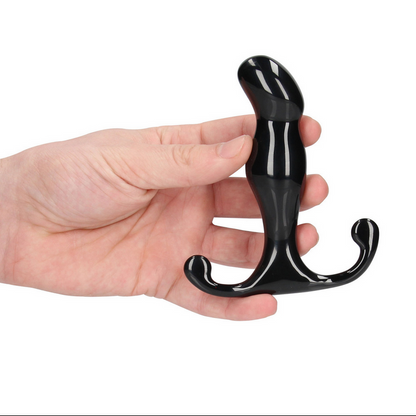 Black prostate massagerr held in a hand against a white background