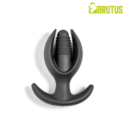 A matte black silicone anal plug with a curved base and a central ribbed shaft, shown on a clean white background with a green and yellow BRUTUS logo in the top right corner.