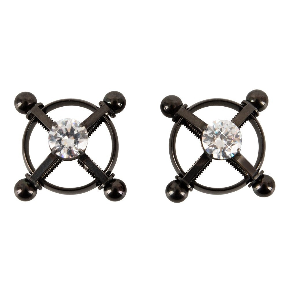 Pair of black metal nipple clamps with clear gemstones on a white background