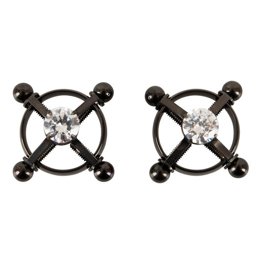 Pair of black metal nipple clamps with clear gemstones on a white background