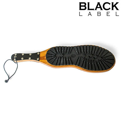 Black and wooden paddle with 'Black Label' branding on a white background