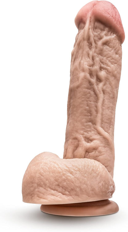 Realistic silicone model of a penis on a white background