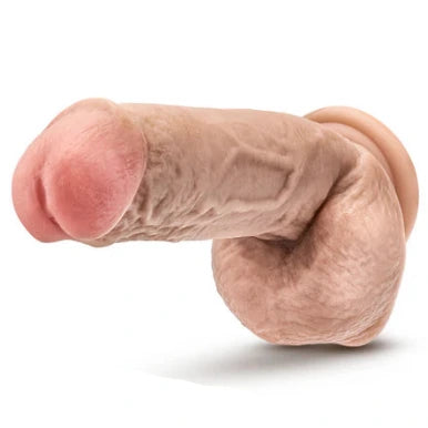 Realistic silicone model of a penis on a white background