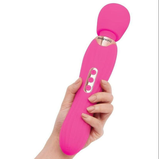 Pink electronic massage wand held by a hand on a white background
