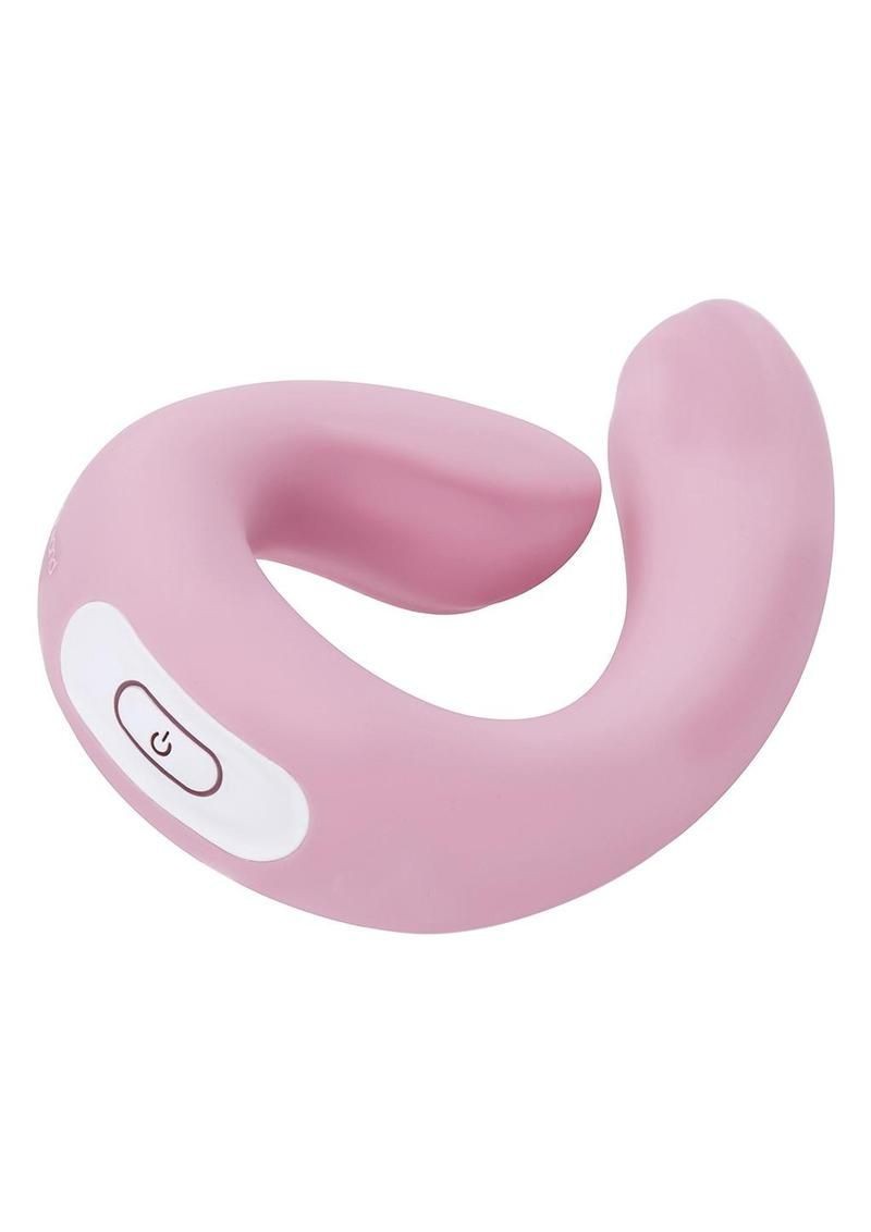 Pink silicone vibrator with a power button on a white background