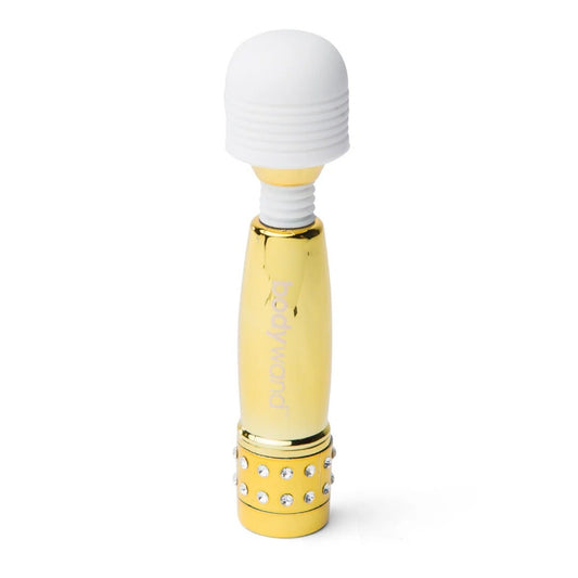 Gold and white handheld massager on a white background