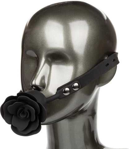 Black leather muzzle with rose design on a mannequin head against a white background