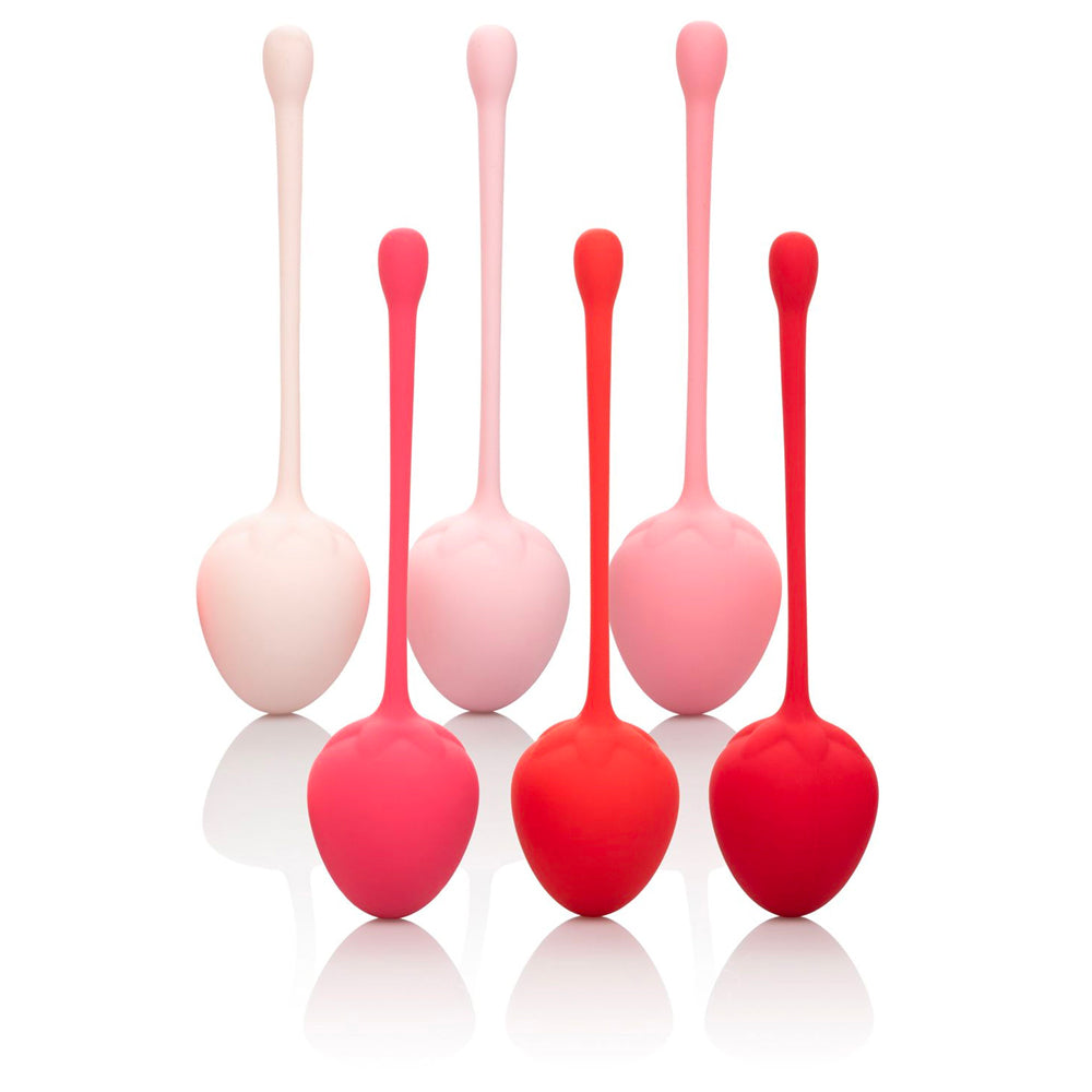 Set of red and pink silicone massage tools on a white background