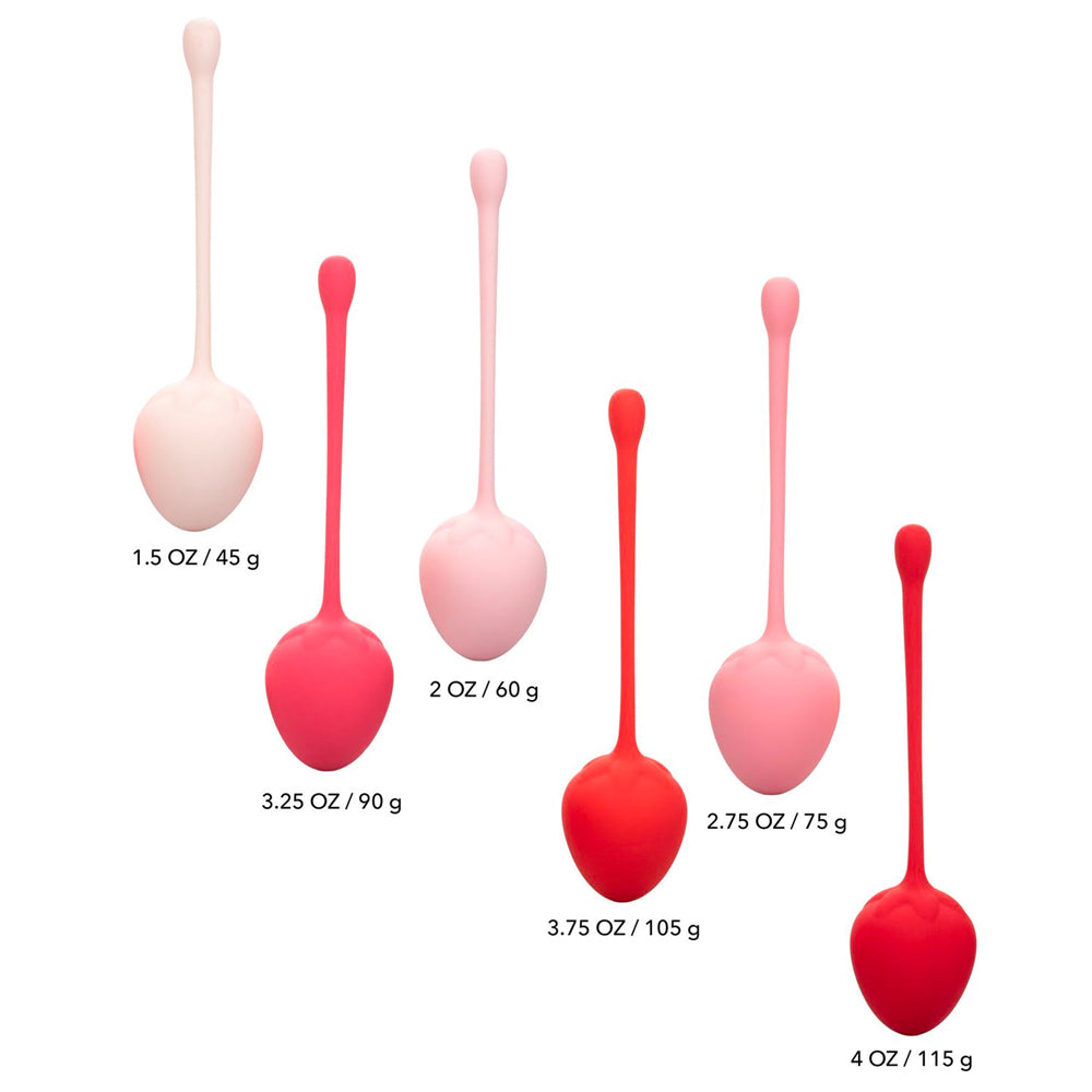Set of pink and red silicone kegel balls with measurements on a white background