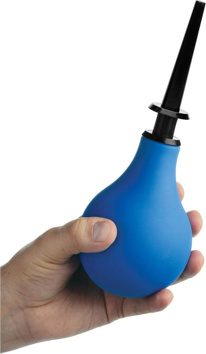 Blue balloon douche pump held in a hand against a white background