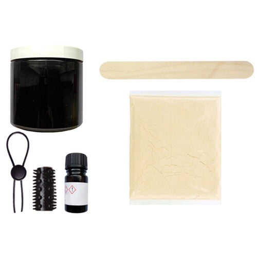Collection of items including a black container, brush, bottle, wooden stick, and cloth on a white background
