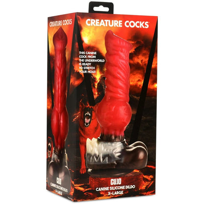 Red silicone dildo in packaging with fiery background and 'Creature Cocks' branding.