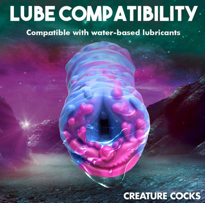 Futuristic pink and blue creature with text about lubricant compatibility on a space-themed background