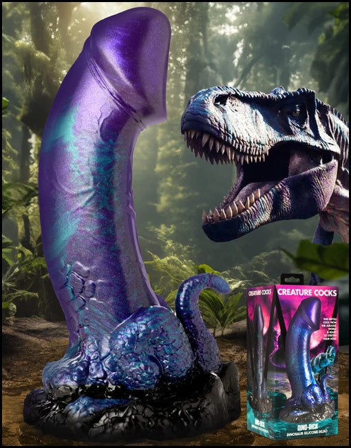 Purple dinosaur sex toy with a box labeled 'Creature Cocks' in a forest setting