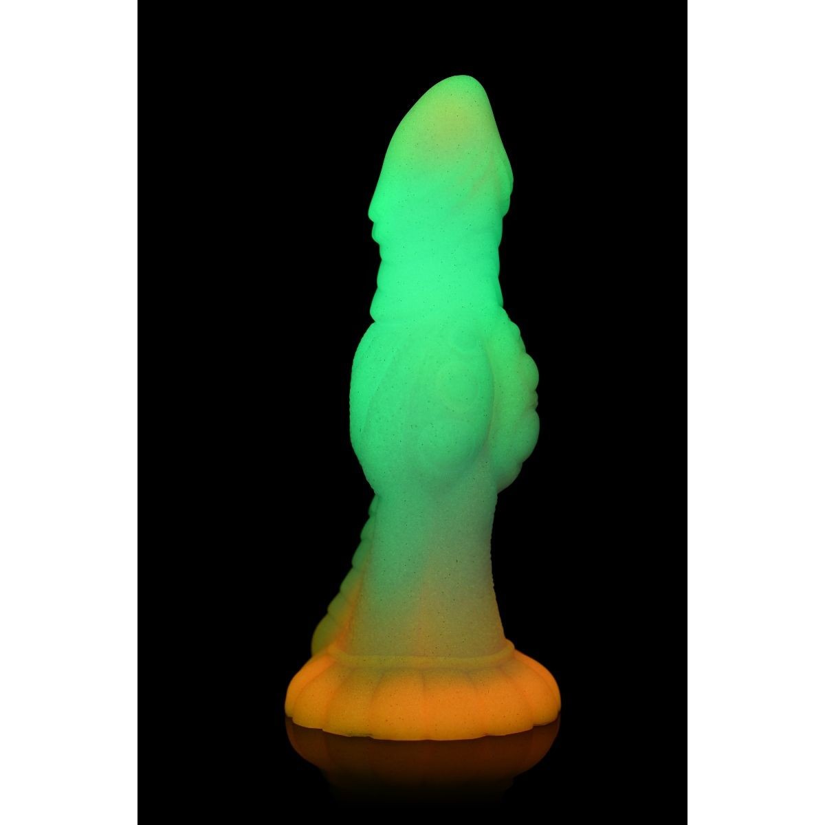 Glowing green and orange object on a black background