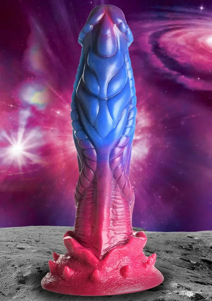 Colorful alien-like creature dildo on a space-themed background