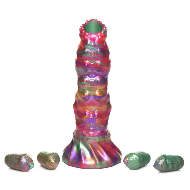 Multicolored cylindrical dildo with smaller green cylindrical eggs on a white background