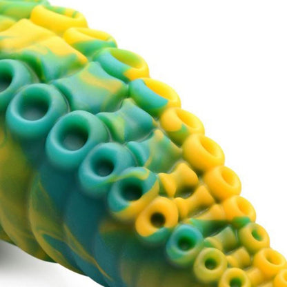 Close-up of a green and yellow silicone mold with circular and star-shaped cavities.