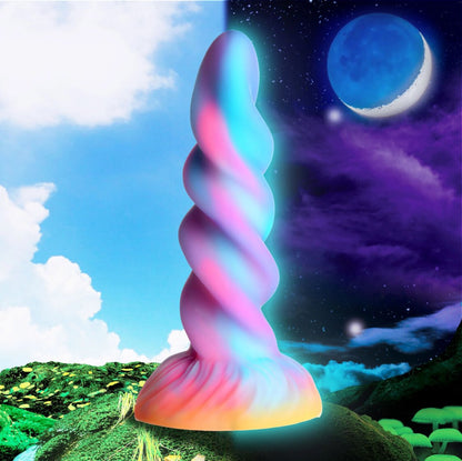 Colorful spiral object in a fantasy landscape with sky and clouds.
