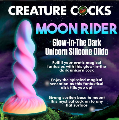 Glow-in-the-dark unicorn silicone dildo with promotional text on a fantasy-themed background