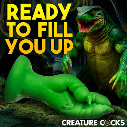 Green dildo product with a dinosaur-like creature in the background, text 'READY TO Fill YOU UP' and 'CREATURE COCKS'.