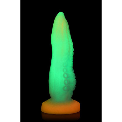 Glowing green and yellow object on a black background