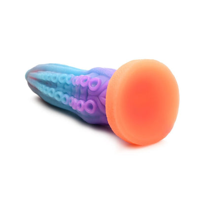 Colorful sex toy with blue, purple, and orange sections on a white background