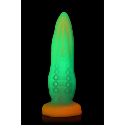 Glowing green and orange object on a black background
