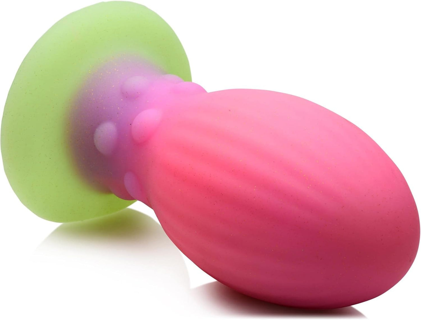 Pink and green anal plug on a white background