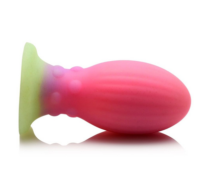 Pink and green silicone butt plug on a white background