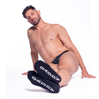 Man wearing black 'DADDY' socks on a white background