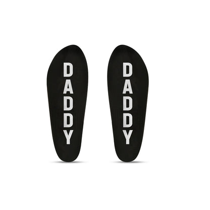 Two black socks with 'DADDY' printed on them against a white background