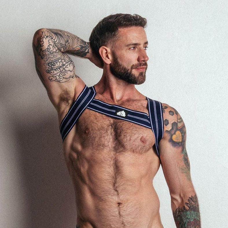 Man wearing a blue athletic bra and underwear set with matching socks against a plain background