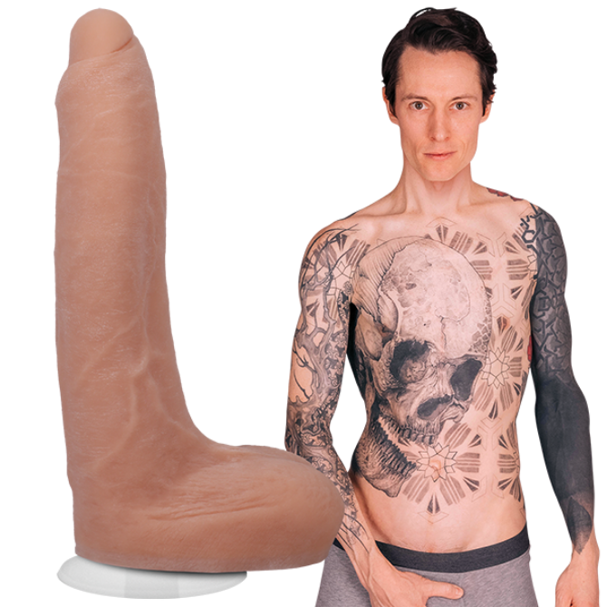 Man with tattoos next to a large anatomical model of a penis on a white background