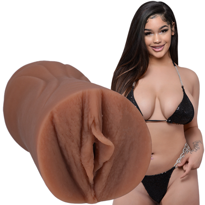 Close-up of a brown silicone stroker with a model wearing a black bikini in the background.