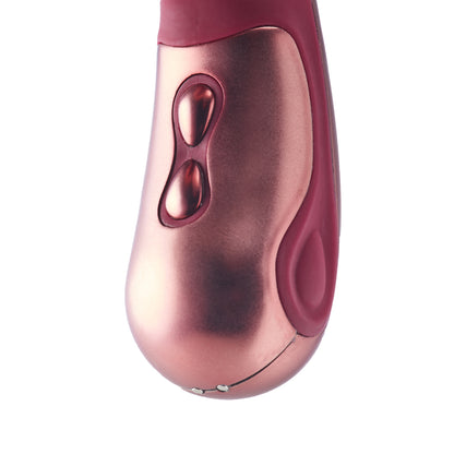 Close-up of a pink and red electronic massage device on a white background