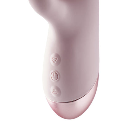 Close-up of a pink electronic device with control buttons on a white background