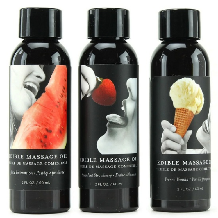 Three bottles of edible massage oil with labeled images on black labels.