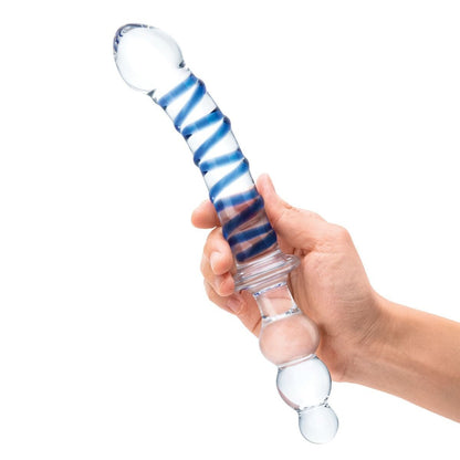 Glass dildo with blue and white striped design held by a hand on a white background