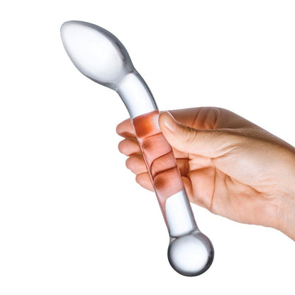 Hand holding a clear glass dildo with a white handle on a white background